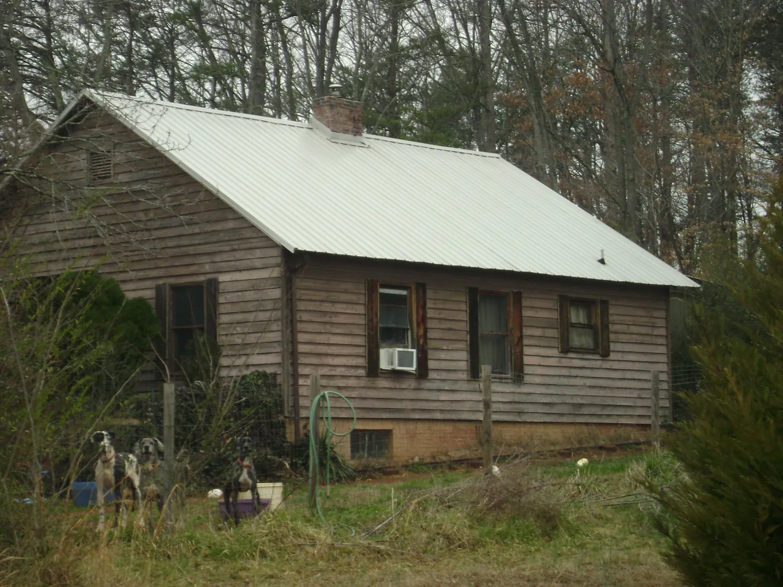 White metal roof on an old wood sided farmhouse, from a Metal Roof Installation job in Corydon